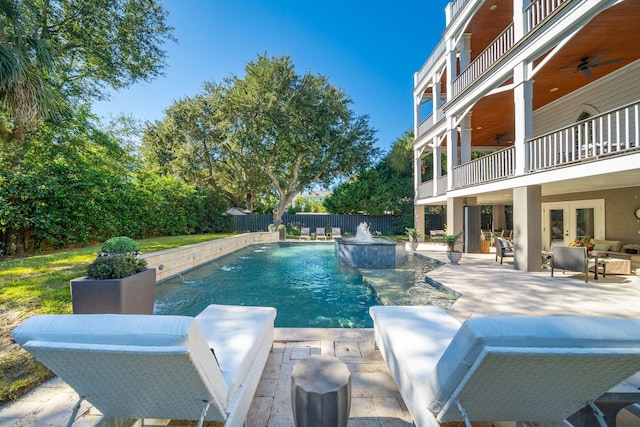 view of swimming pool with pool water feature, a patio, ceiling fan, and outdoor lounge area