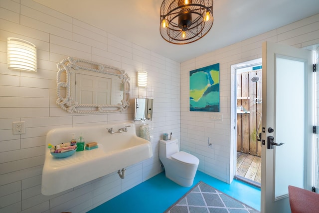 bathroom with tile walls and toilet