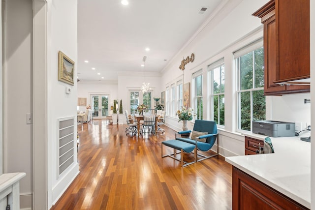 interior space with plenty of natural light, light hardwood / wood-style floors, and a chandelier