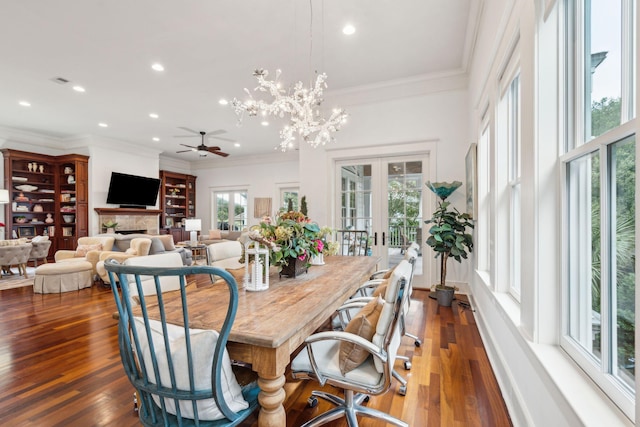 dining room with ceiling fan, french doors, dark wood-type flooring, and crown molding