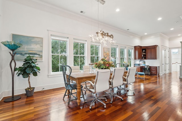 dining room featuring ornamental molding, an inviting chandelier, and dark wood-type flooring