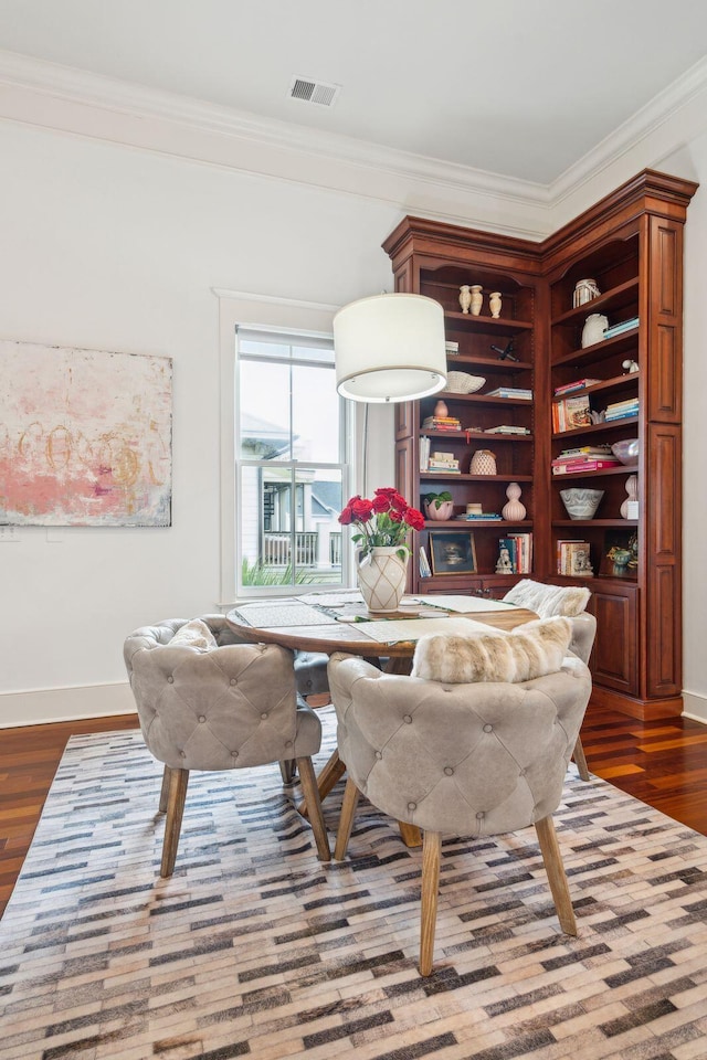 dining room featuring wood-type flooring and ornamental molding