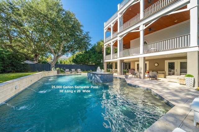 view of swimming pool with an outdoor hangout area, pool water feature, and a patio area