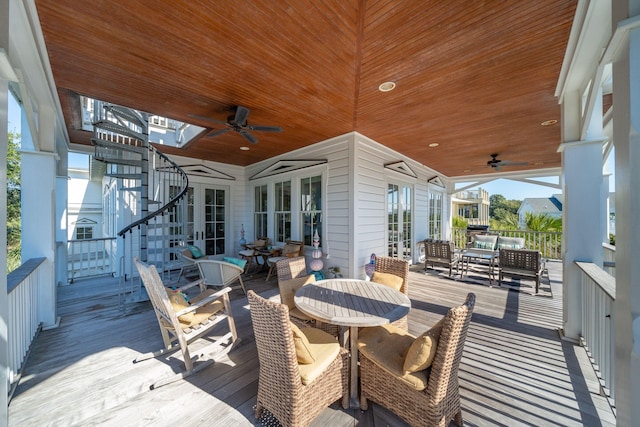 wooden deck featuring ceiling fan and an outdoor living space