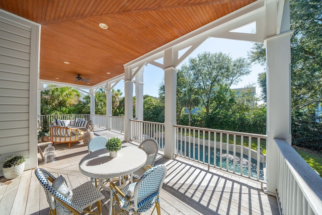 wooden terrace featuring ceiling fan