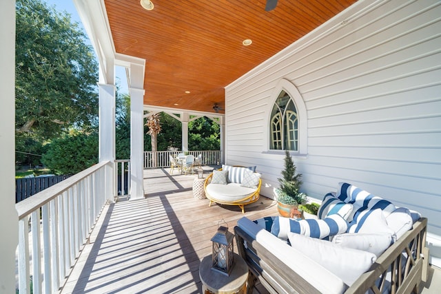 wooden terrace with covered porch and an outdoor hangout area