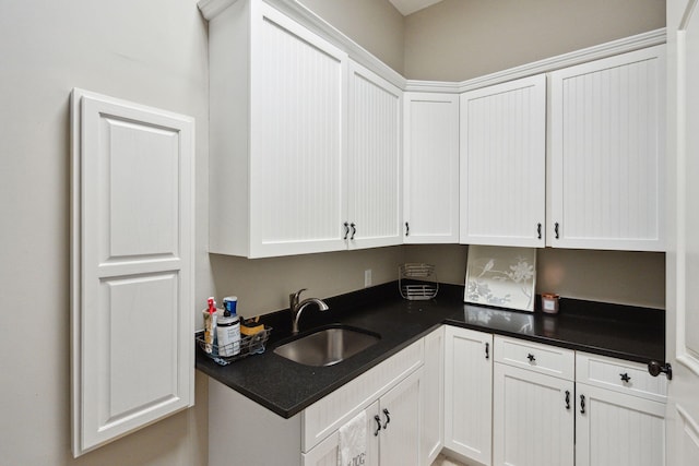 kitchen featuring white cabinets and sink