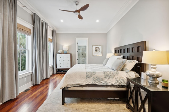 bedroom featuring multiple windows, ornamental molding, ceiling fan, and dark wood-type flooring