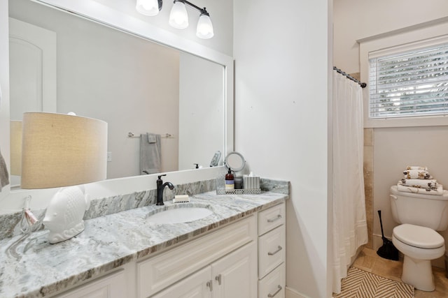 bathroom with vanity, toilet, and tile patterned floors