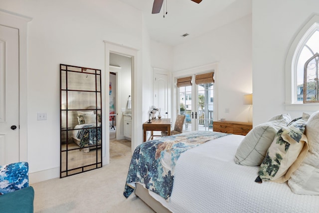 bedroom with connected bathroom, ceiling fan, light colored carpet, and access to outside