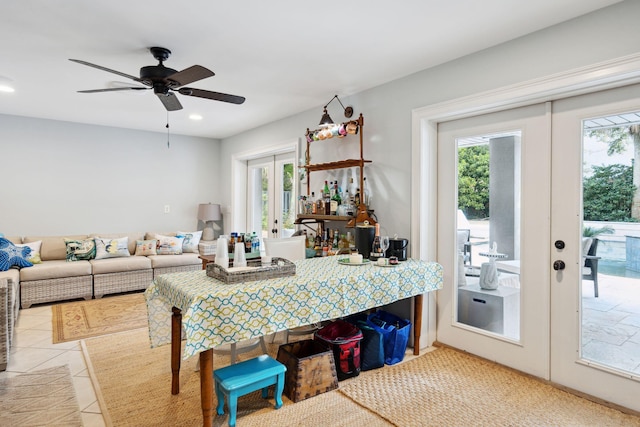 tiled dining room with ceiling fan, french doors, and plenty of natural light