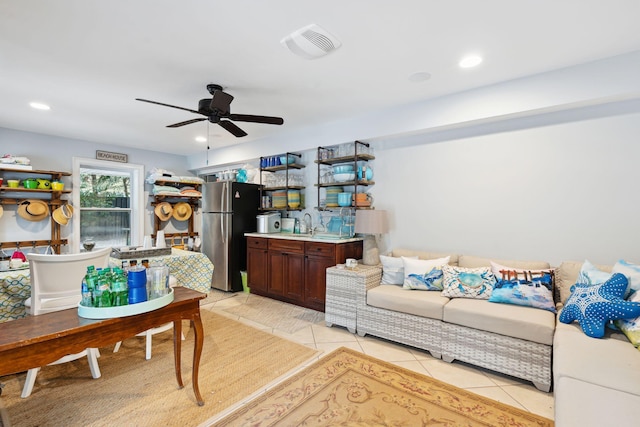 tiled living room featuring ceiling fan