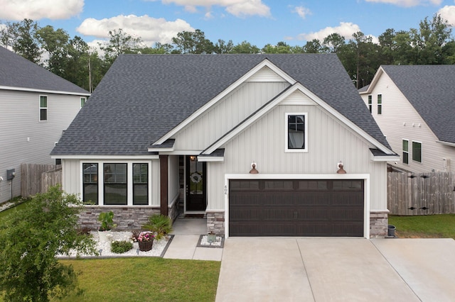 404 Omaha Dr, Moncks Corner, SC 29461 - view of front facade with stone siding, driveway, roof with shingles, and board and batten siding