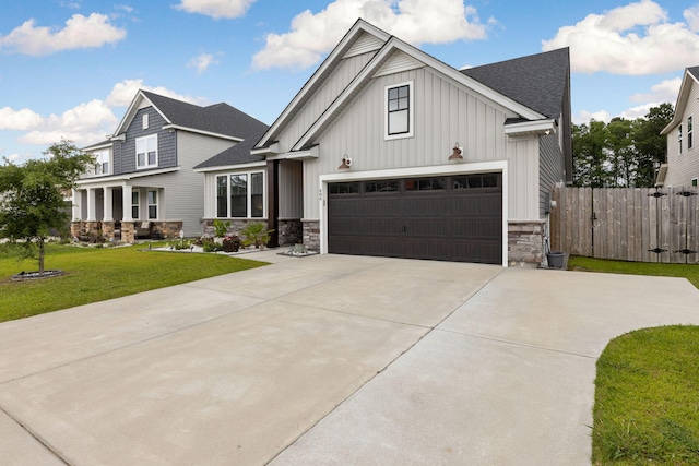 404 Omaha Dr, Moncks Corner, SC 29461 - view of front facade with board and batten siding, stone siding, concrete driveway, and roof with shingles