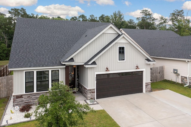 404 Omaha Dr, Moncks Corner, SC 29461 - modern farmhouse style home with stone siding, roof with shingles, driveway, and board and batten siding