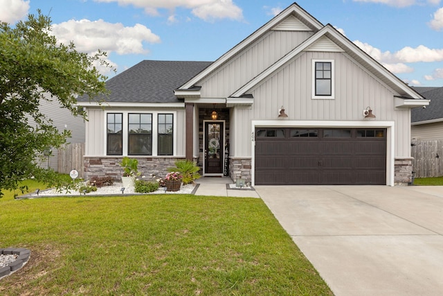 404 Omaha Dr, Moncks Corner, SC 29461 - view of front facade featuring board and batten siding, concrete driveway, stone siding, and a garage