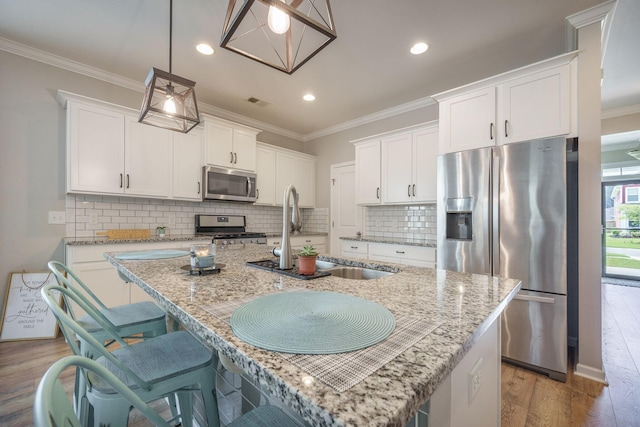 419 Whispering Breeze Ln, Summerville, SC 29486 - kitchen featuring appliances with stainless steel finishes, ornamental molding, a sink, and wood finished floors