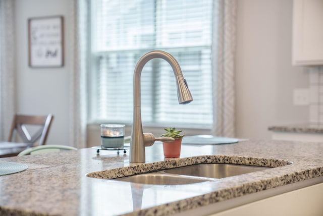 419 Whispering Breeze Ln, Summerville, SC 29486 - interior details with a sink, white cabinets, and light stone countertops