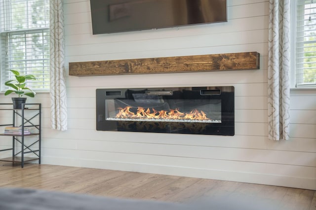 419 Whispering Breeze Ln, Summerville, SC 29486 - interior details featuring a glass covered fireplace, wood finished floors, and wooden walls