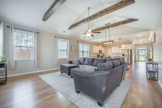 419 Whispering Breeze Ln, Summerville, SC 29486 - living area featuring light wood-style floors, a ceiling fan, baseboards, vaulted ceiling with beams, and visible vents
