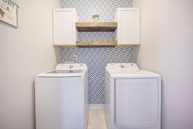 419 Whispering Breeze Ln, Summerville, SC 29486 - washroom with washer and dryer, light tile patterned flooring, wallpapered walls, and cabinet space