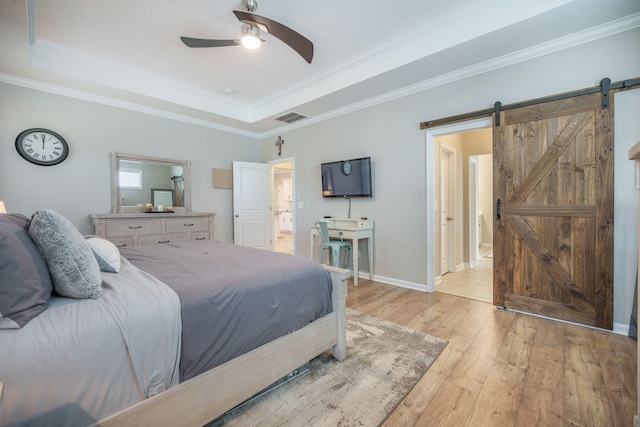 419 Whispering Breeze Ln, Summerville, SC 29486 - bedroom with visible vents, a barn door, ornamental molding, a tray ceiling, and light wood-style flooring