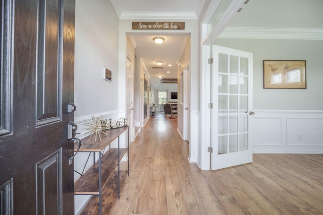 419 Whispering Breeze Ln, Summerville, SC 29486 - foyer with crown molding, a decorative wall, a wainscoted wall, french doors, and light wood-style flooring