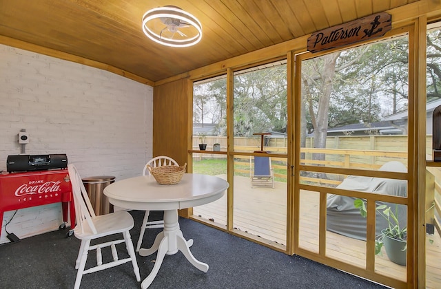 sunroom / solarium featuring wood ceiling