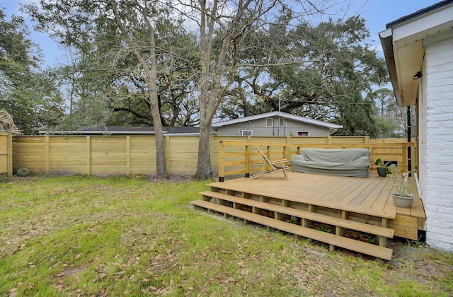 view of yard featuring a fenced backyard and a wooden deck