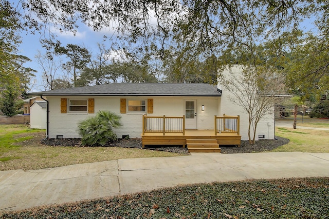 view of front facade with crawl space, a front yard, a deck, and brick siding