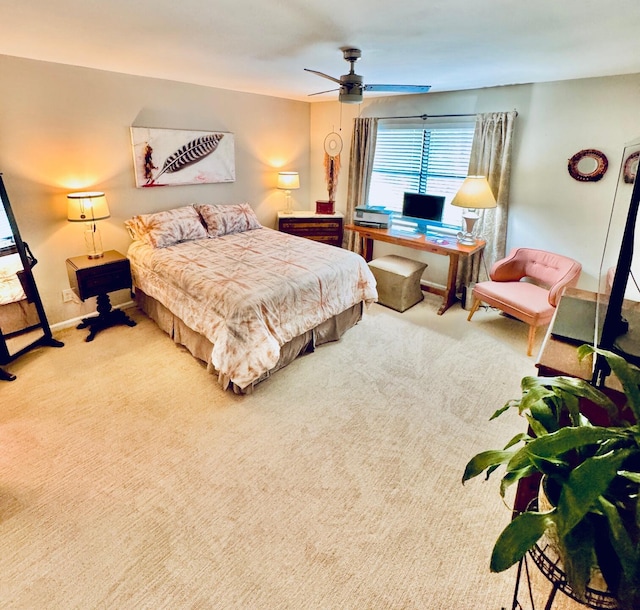 carpeted bedroom with baseboards and a ceiling fan