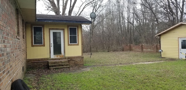 view of yard featuring entry steps and fence