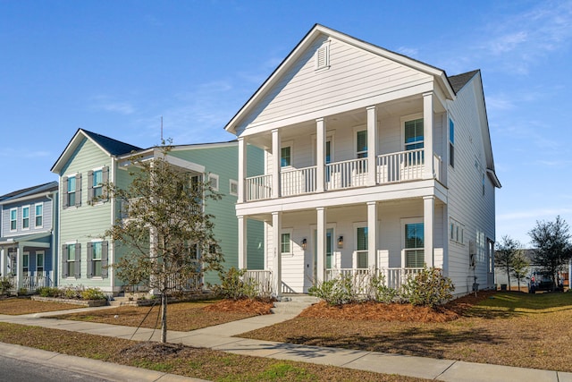 view of front of property with a balcony and covered porch