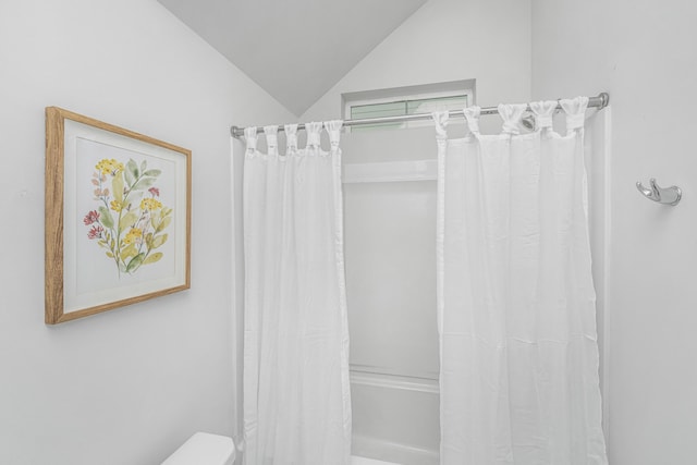 bathroom with toilet, vaulted ceiling, and shower / bath combo