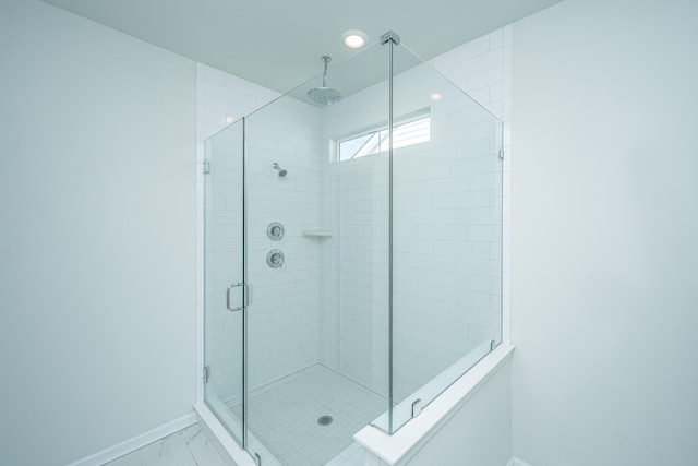 bathroom featuring a shower with shower door