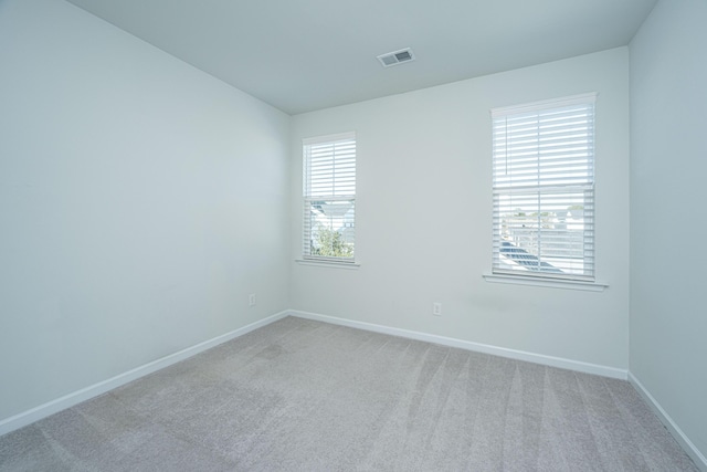 unfurnished room featuring light colored carpet