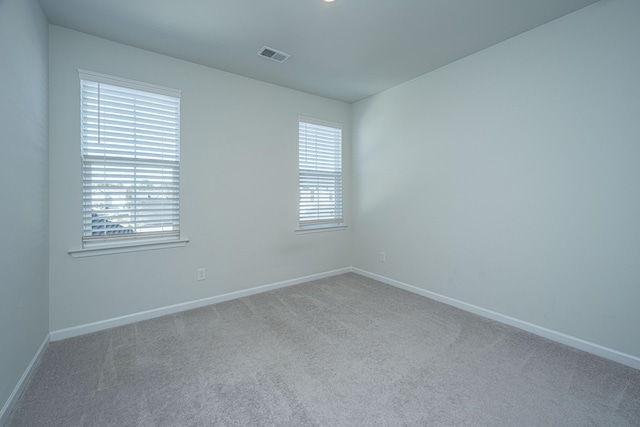 unfurnished room with light carpet