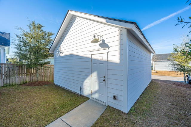 view of outbuilding featuring a yard