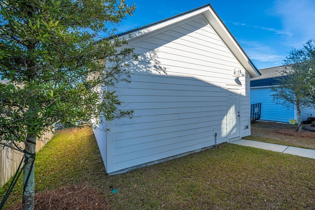 view of side of home with a lawn