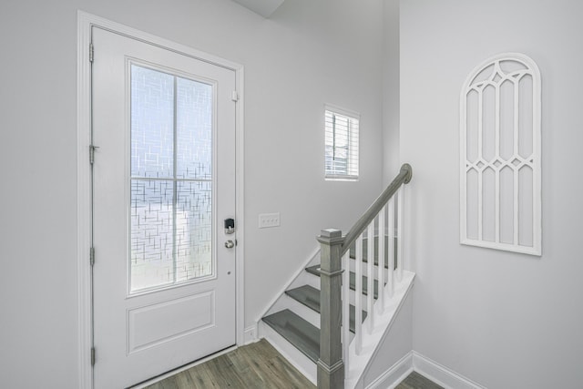 entryway with dark hardwood / wood-style flooring