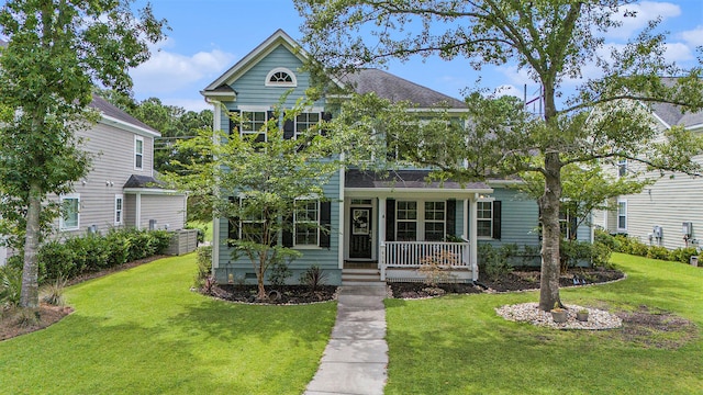 view of front of property with covered porch and a front lawn