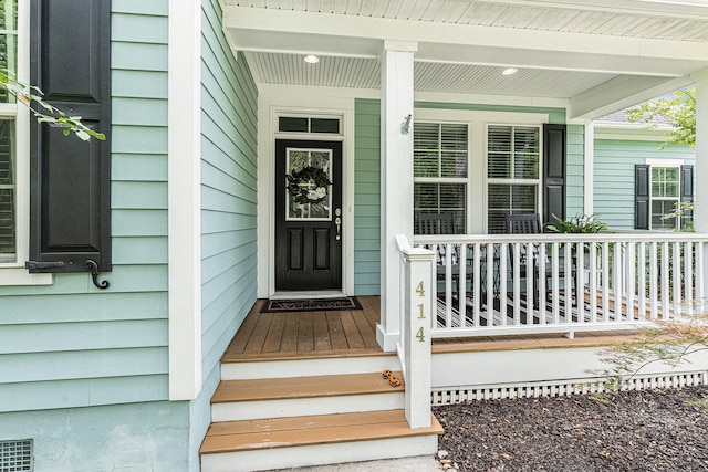 view of exterior entry featuring a porch