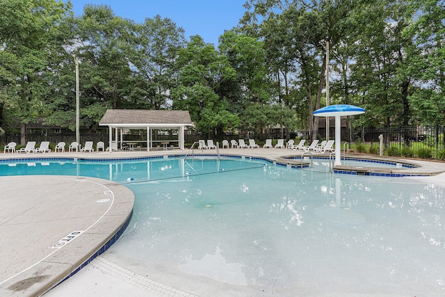 view of swimming pool with a community hot tub and a patio