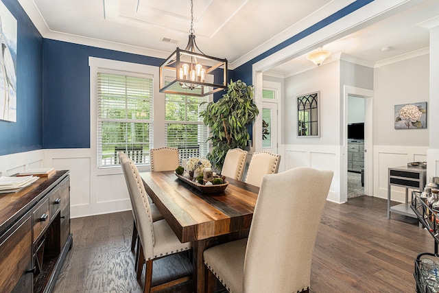 dining space with an inviting chandelier, dark hardwood / wood-style floors, and crown molding