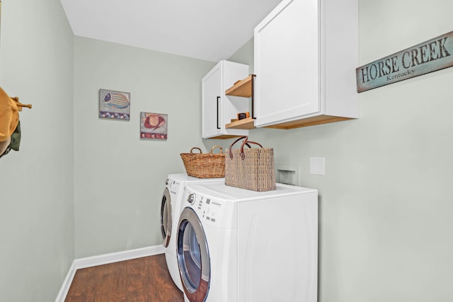 washroom with cabinets, separate washer and dryer, and dark wood-type flooring