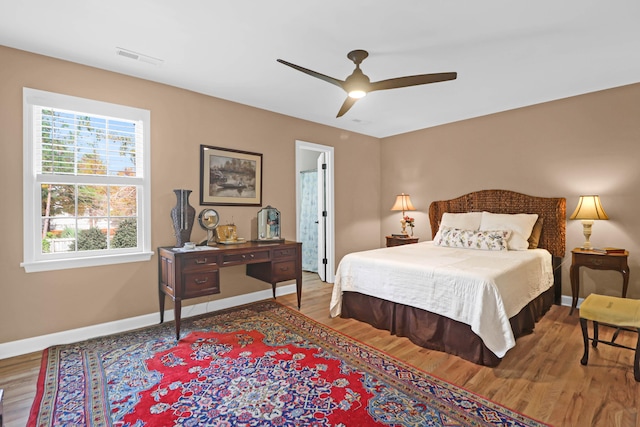 bedroom with ceiling fan and hardwood / wood-style flooring