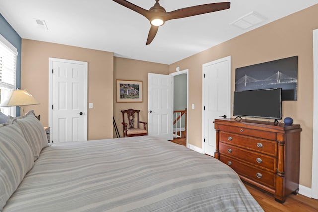 bedroom with ceiling fan and light hardwood / wood-style floors