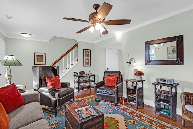 living room featuring crown molding, ceiling fan, and wood-type flooring