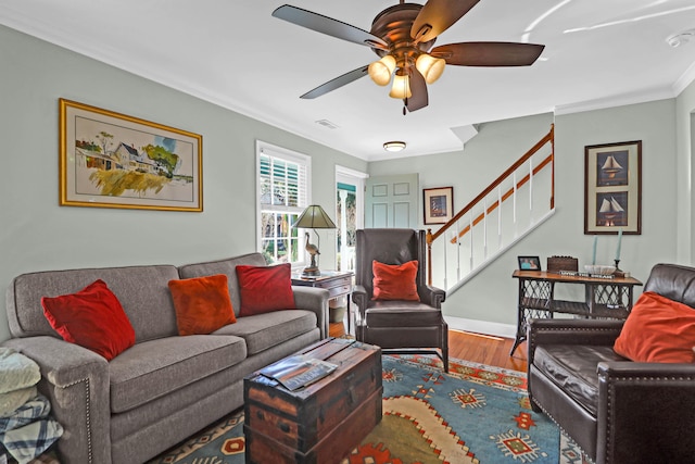 living room with hardwood / wood-style flooring, ceiling fan, and ornamental molding