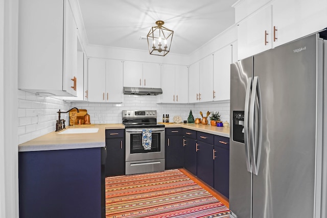 kitchen with blue cabinetry, sink, hanging light fixtures, stainless steel appliances, and white cabinets